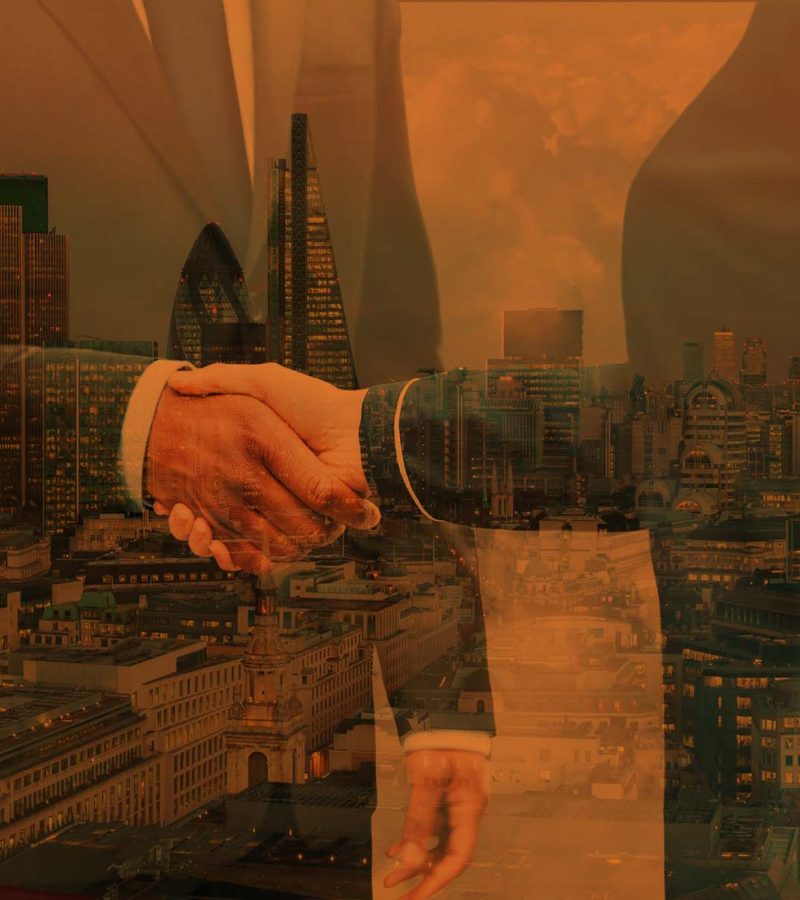 Double exposure of two people shaking hands with The City of London finance district featuring The Heron Tower, Tower 42, The Gherkin, The Cheesgrater, The Walkie Talkie,